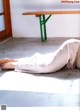 A woman laying on the ground with her legs crossed.